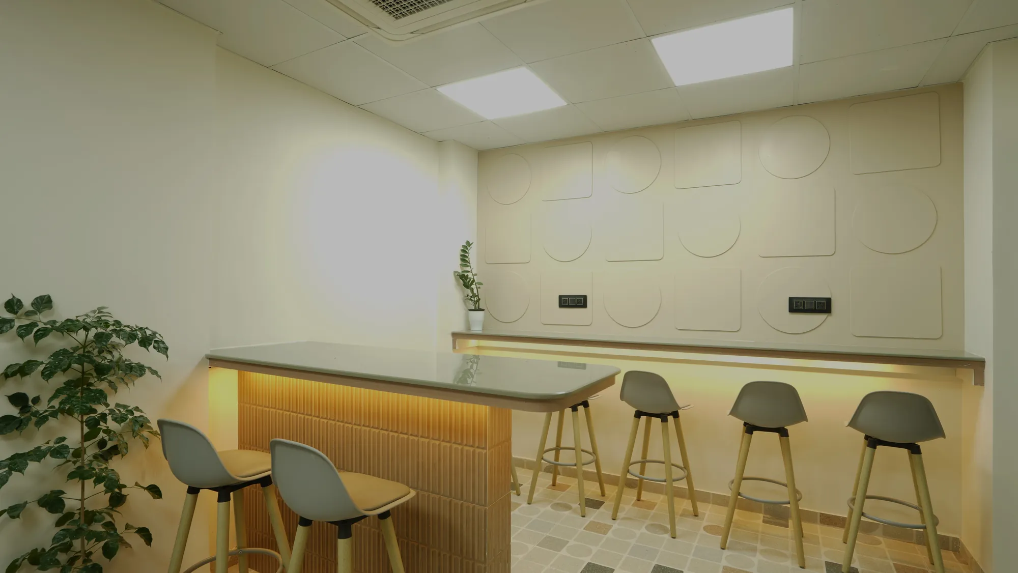Pantry counter with bar stools and a softly lit timber front