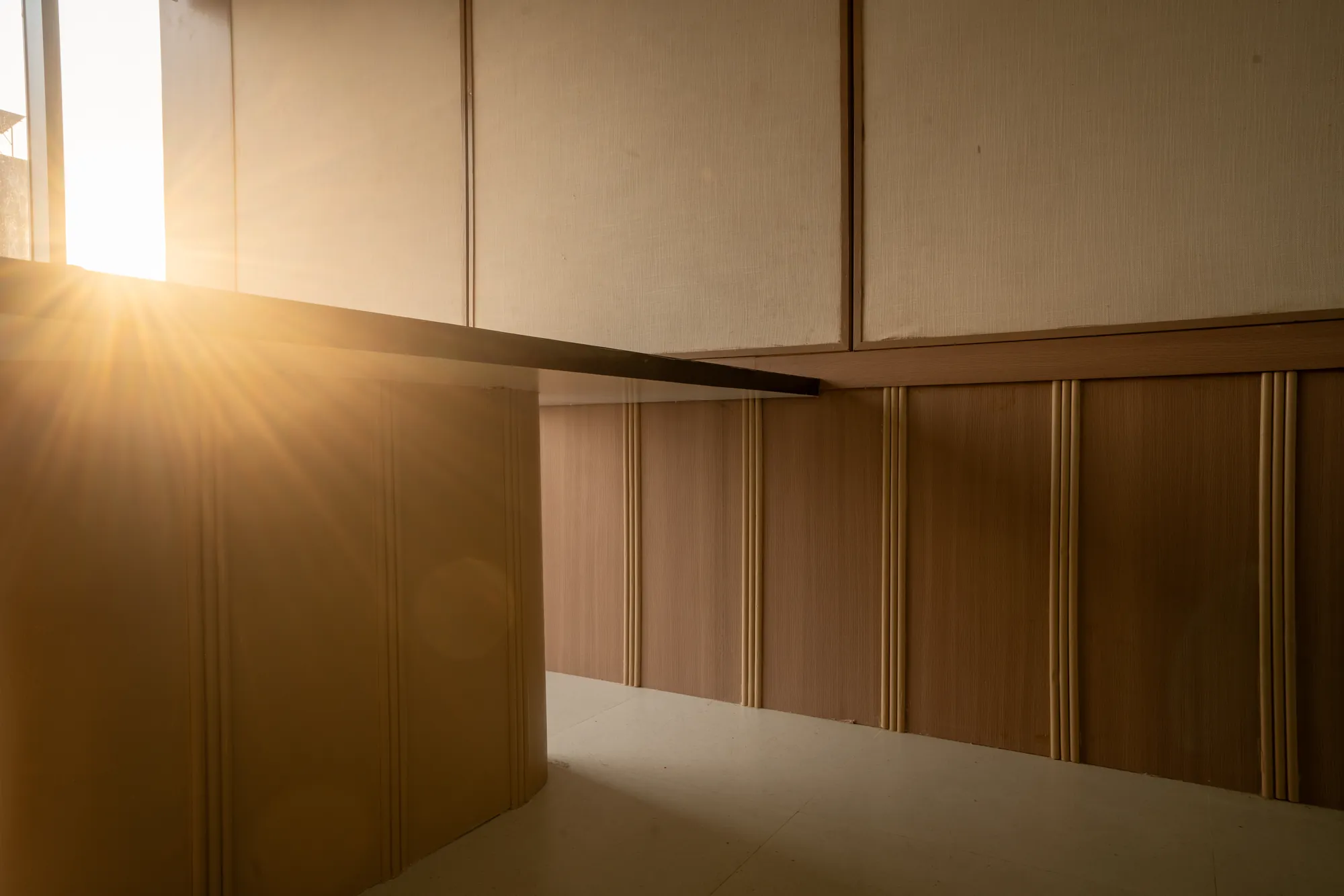 Late sunlight falling across timber panelling at COCO Dev Nagar