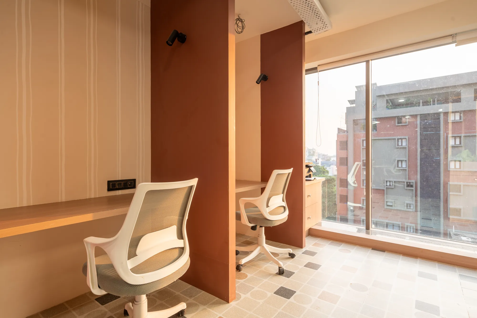 Window workstations divided by terracotta and timber fins