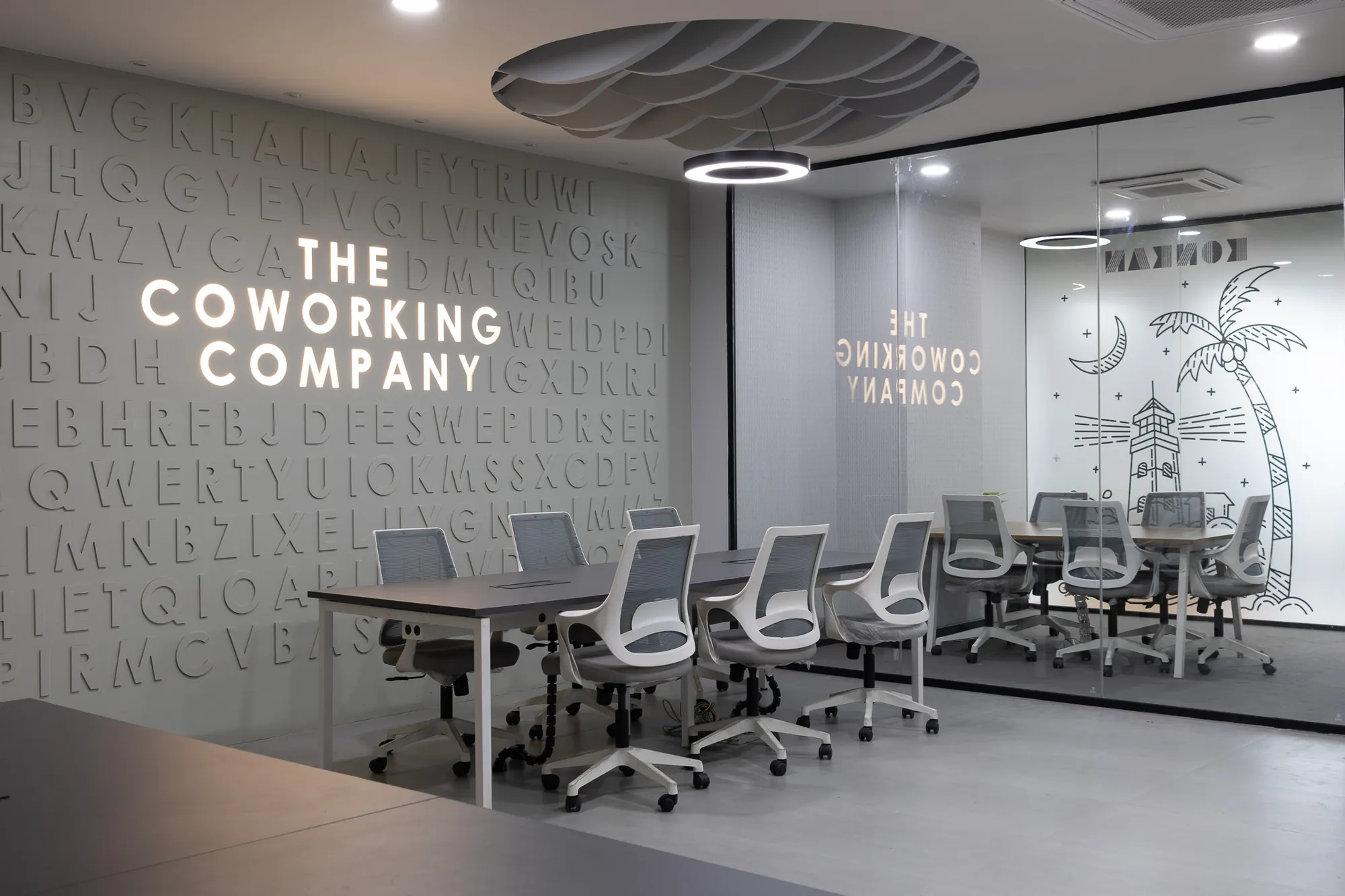 Meeting room with a typographic feature wall and wave-form ceiling panel