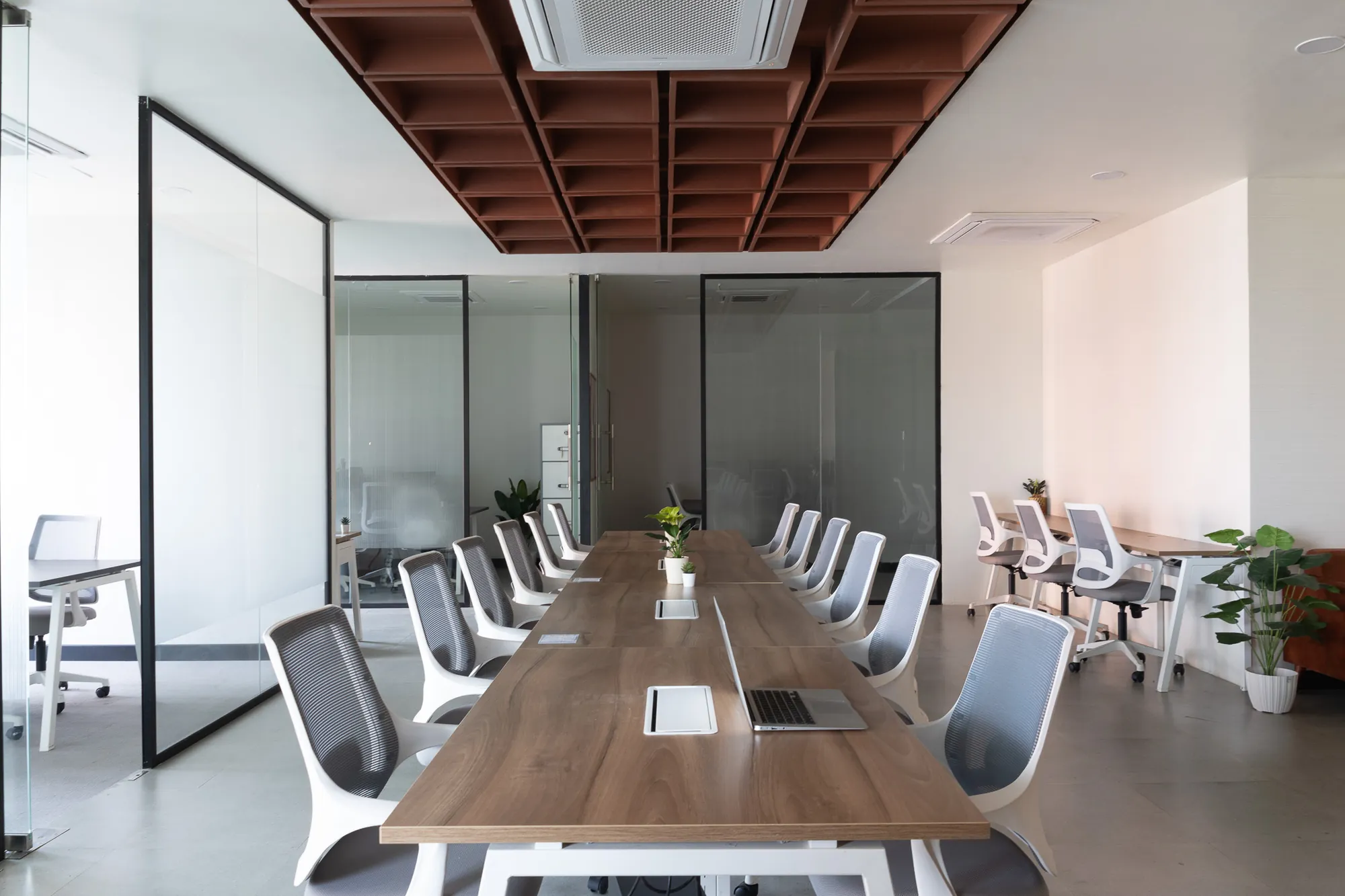 Conference room with a long timber table under a coffered timber ceiling
