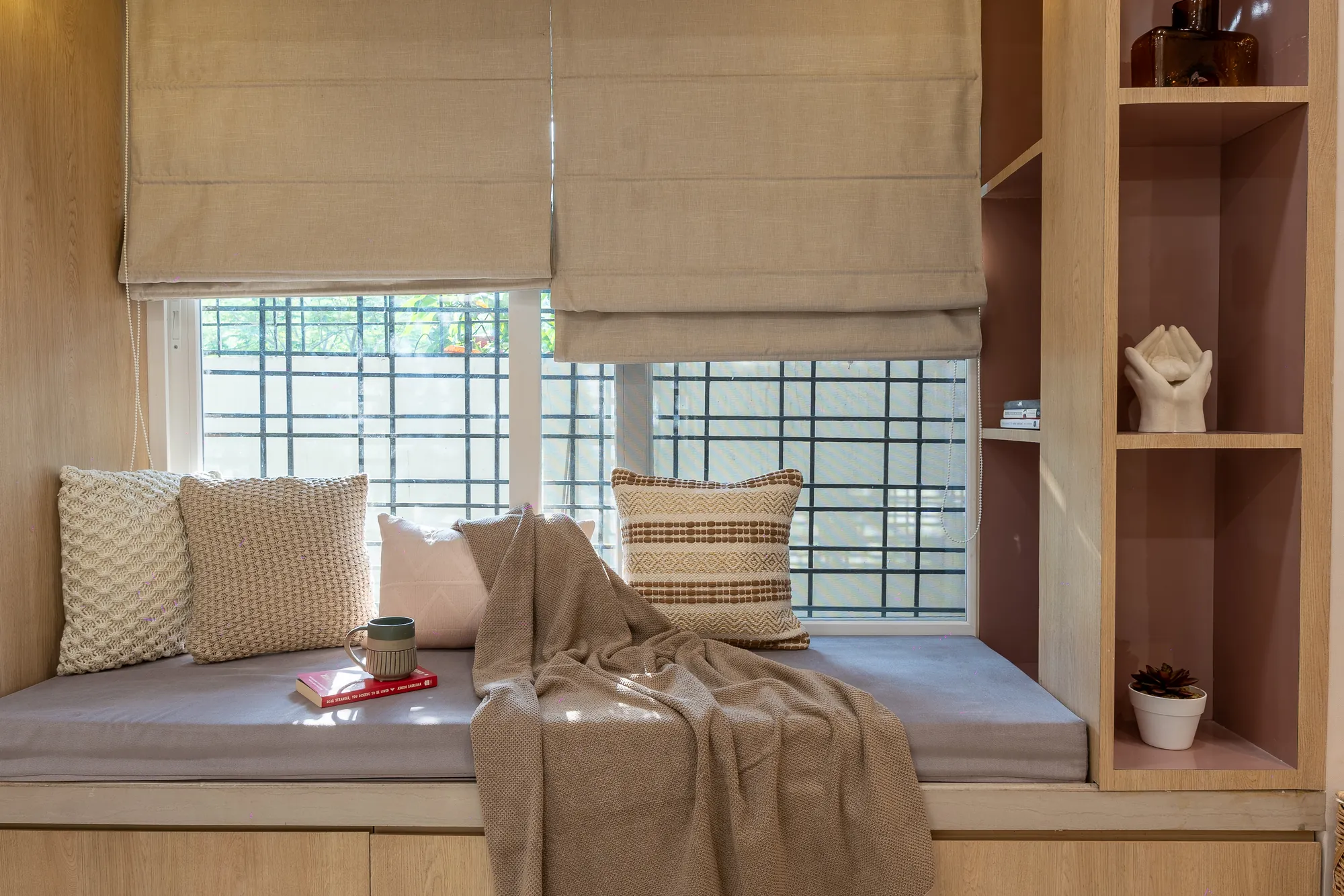 Window seat with cushions, Roman blinds and built-in acacia shelving