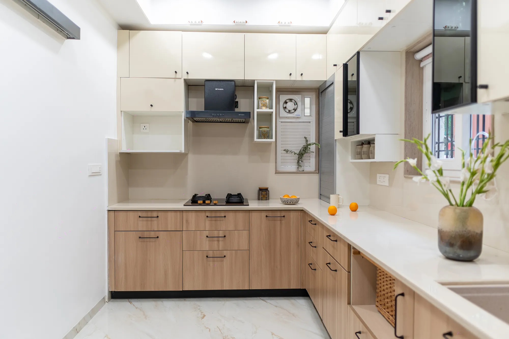 L-shaped kitchen in acacia-toned cabinetry with white upper units