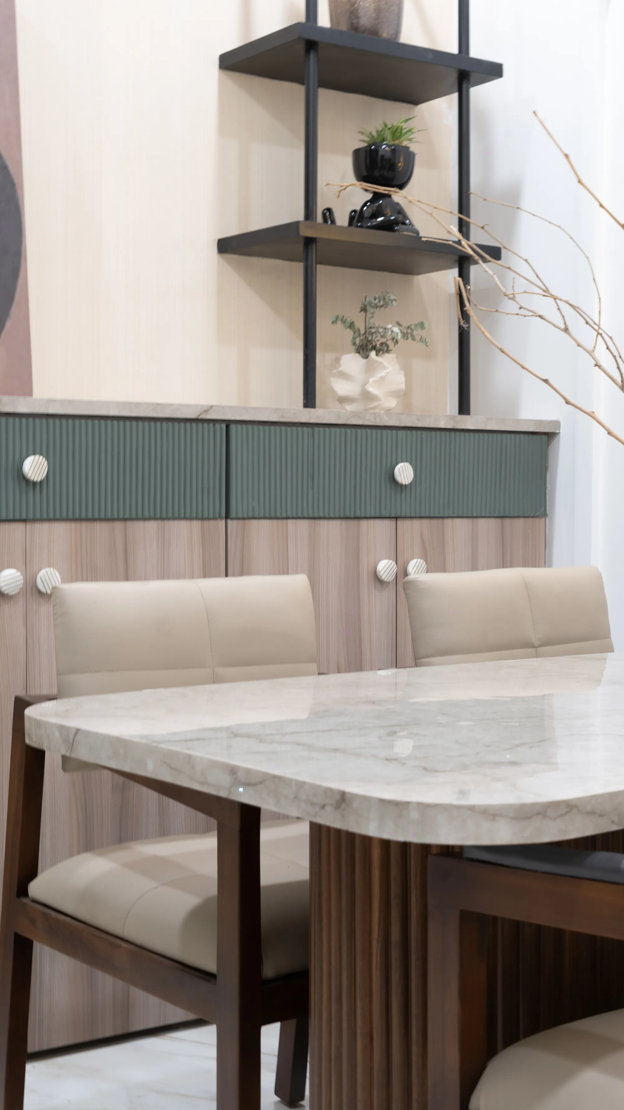 Detail of the dining table with a stone top and fluted wooden base
