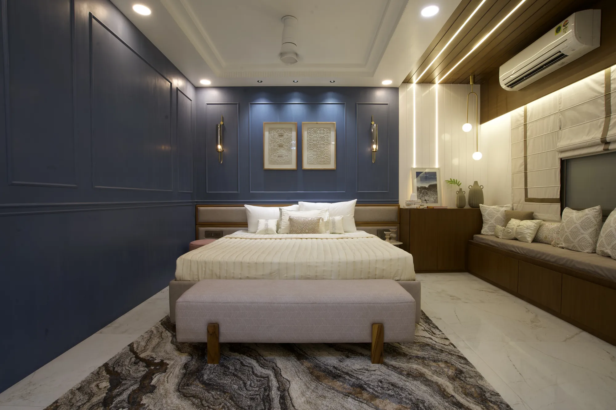 Master bedroom with slate-blue panelled walls, brass sconces and a marbled rug