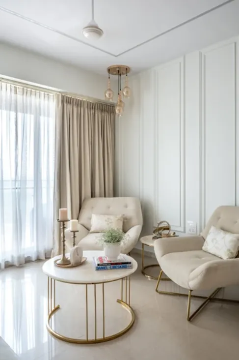 Reading corner with two ivory armchairs and a round marble-topped table
