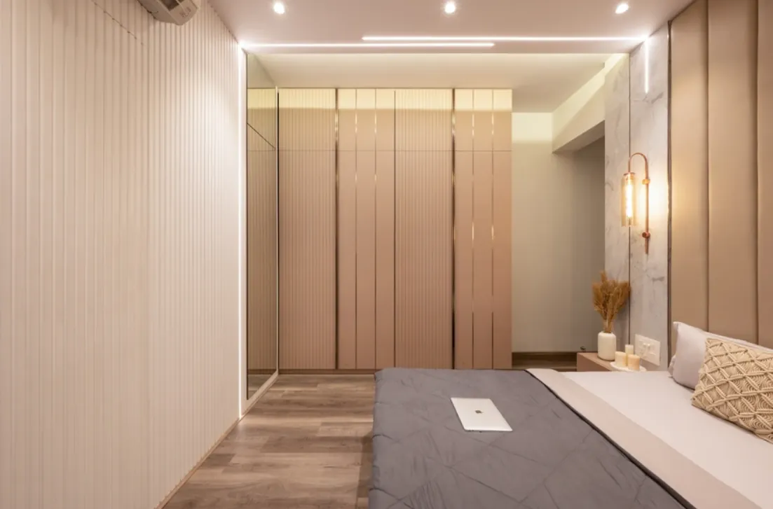 Beige fluted wardrobe wall with integrated lighting