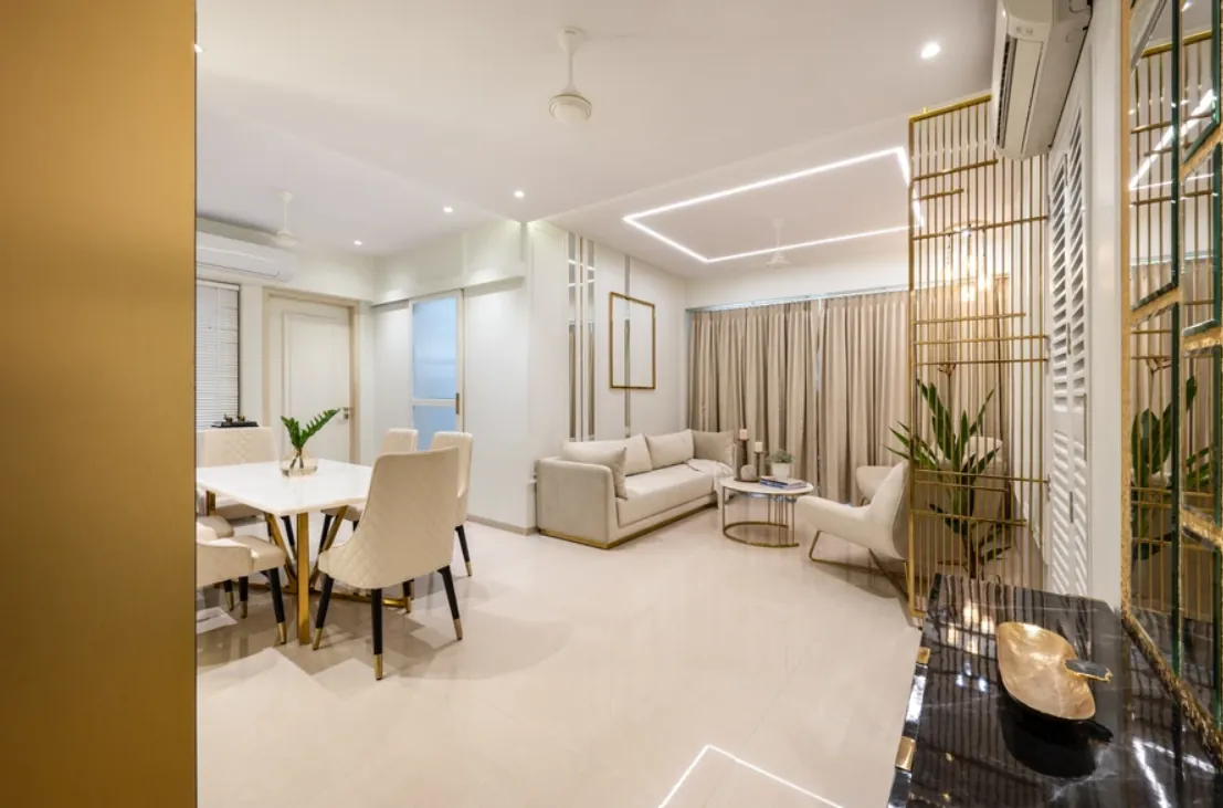 Open living and dining space with a gold lattice screen and cove lighting